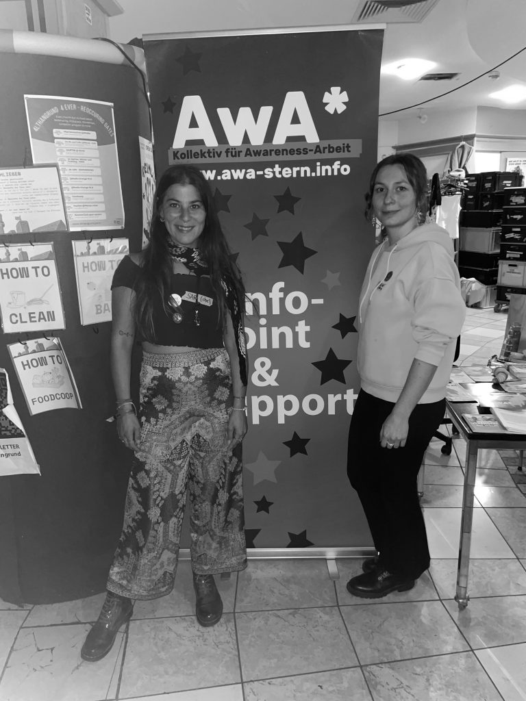 Sari und Gwen vor dem Plakat der Awa*